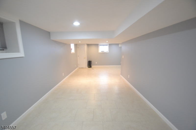 204 Market Street Garfield, NJ 07026 - Photo 34 of 36 a view of a big room with windows and chandelier fan