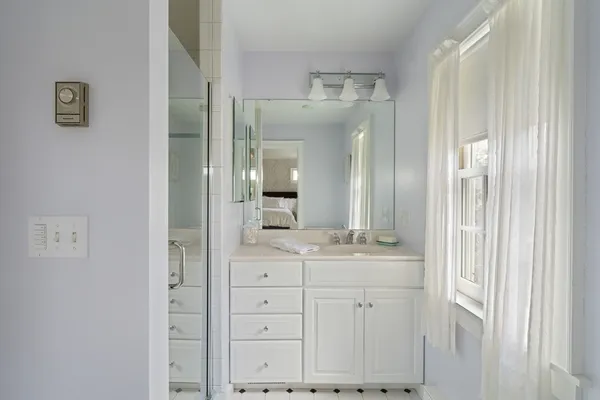 a bathroom with a double vanity sink and mirror