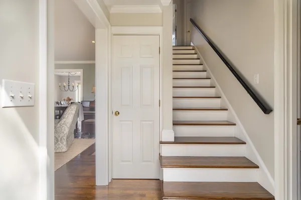 a view of entryway and hall with wooden floor