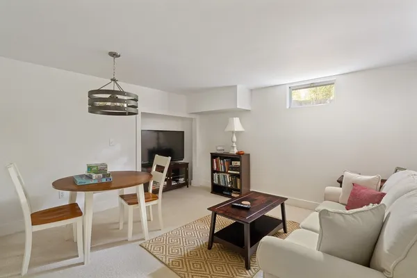 a living room with furniture a rug and a chandelier