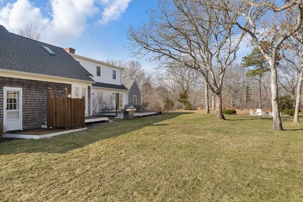 a view of a yard with a house and a tree