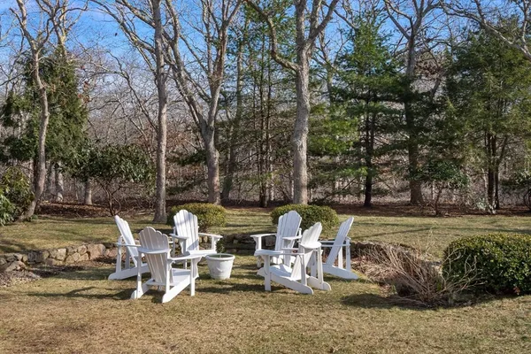 a view of a lake with lawn chairs and couches