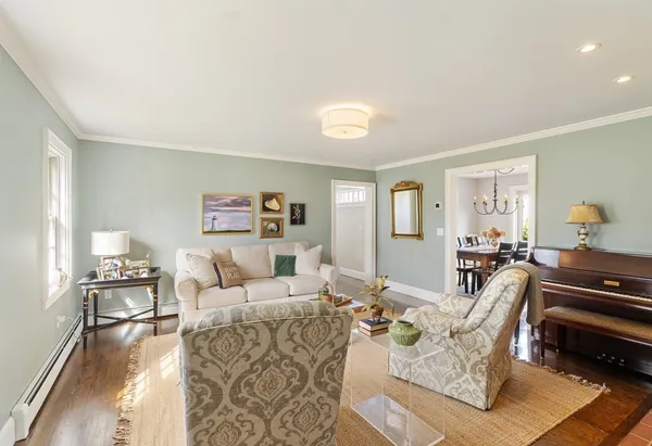 a living room with furniture a rug and a lamp