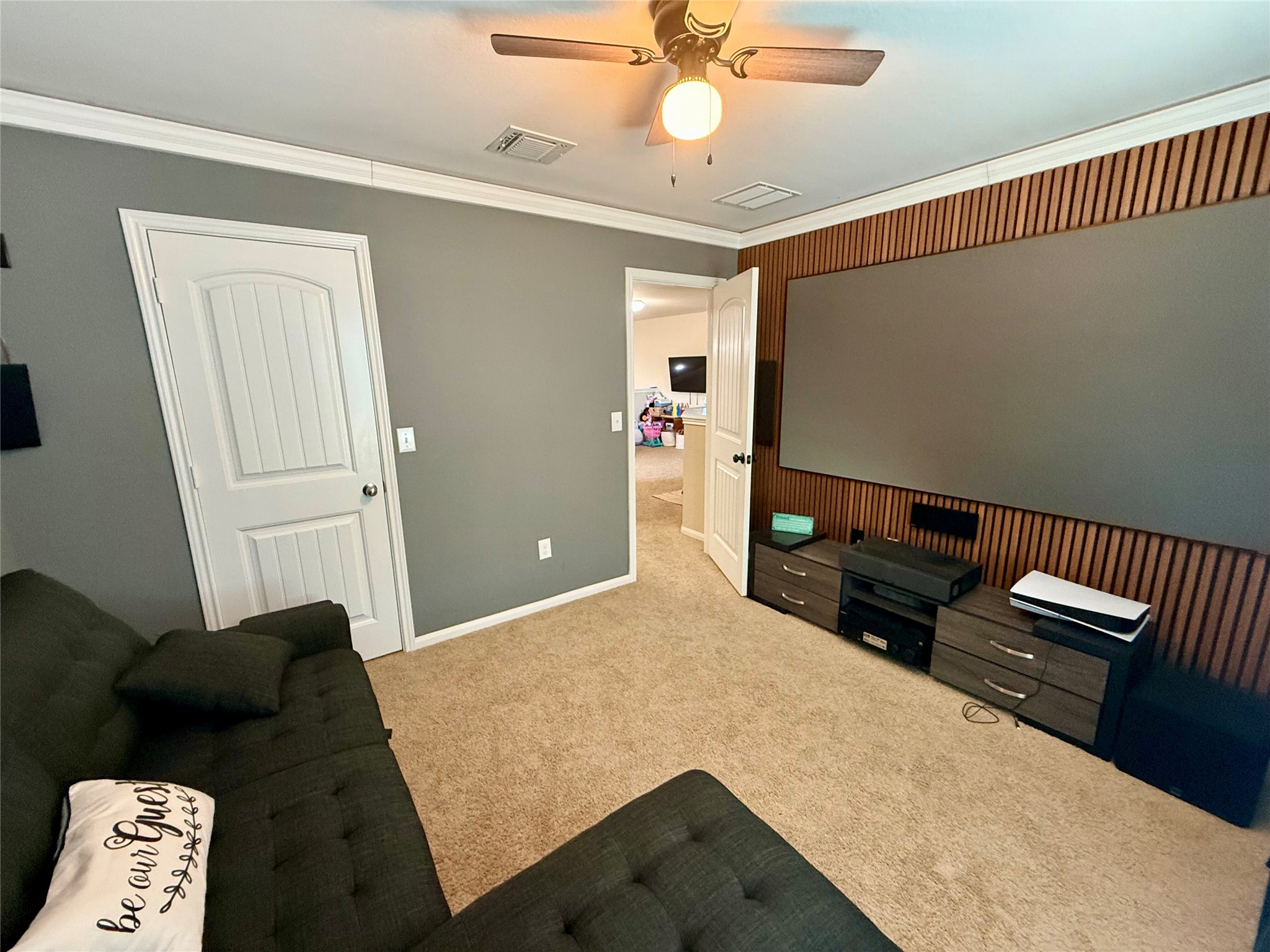 11700 Andesite Road Manor, TX 78653 - Photo 20 of 32 Bedroom for entertainment, featuring crown molding and warm carpet underfoot.