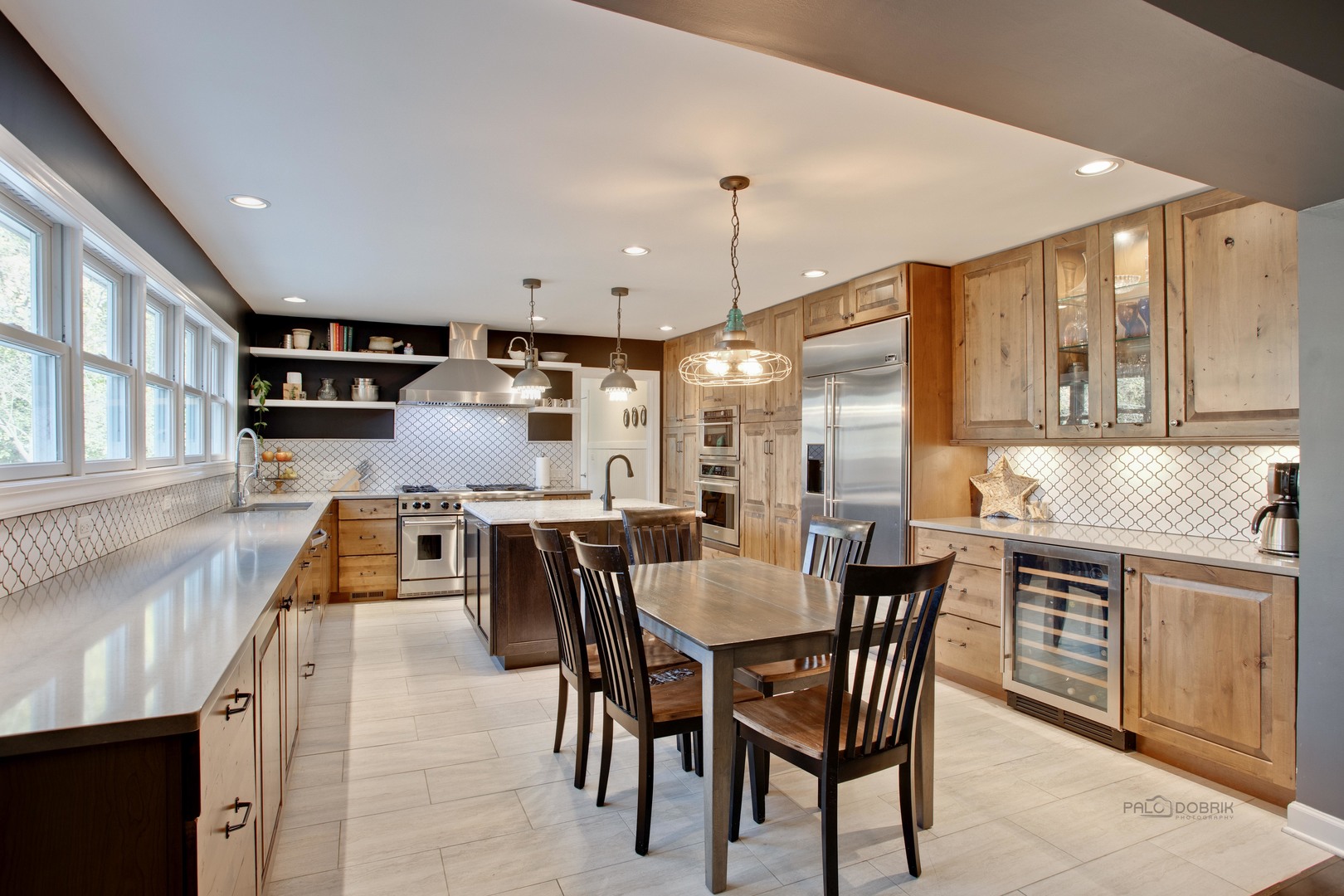 20890 West Exeter Road Kildeer, IL 60047 - Photo 31 of 62 a kitchen with stainless steel appliances kitchen island granite countertop a table chairs and a refrigerator