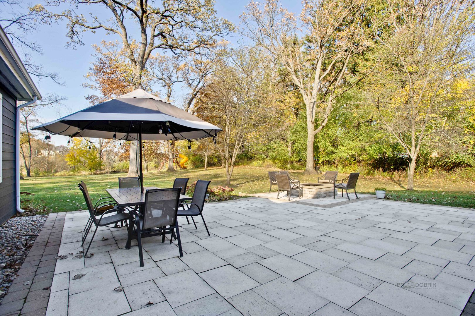 20890 West Exeter Road Kildeer, IL 60047 - Photo 44 of 62 a view of a patio with table and chairs under an umbrella with a barbeque