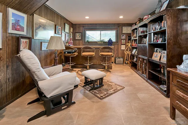 a living room with lots of furniture and a book shelf