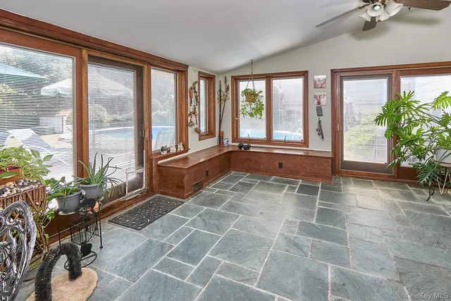 a room with patio furniture and a potted plant