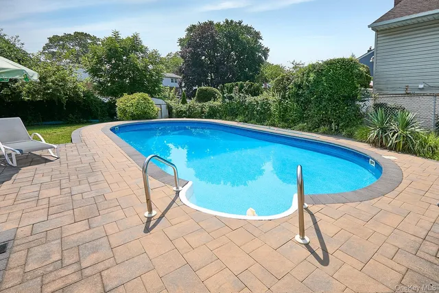 a view of a swimming pool with a patio