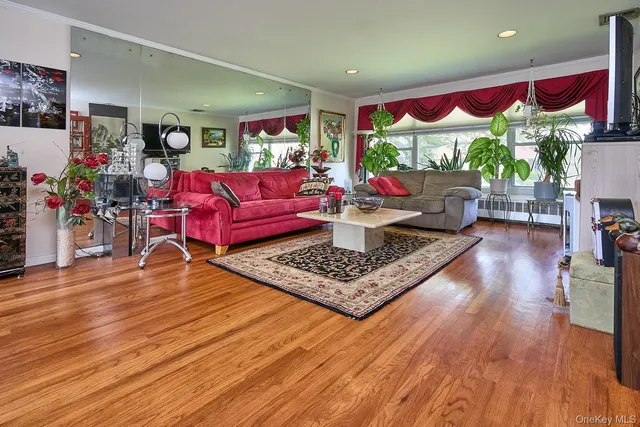 a living room with furniture fireplace and wooden floor