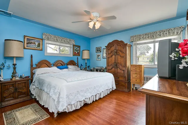 a bedroom with bed and a chandelier