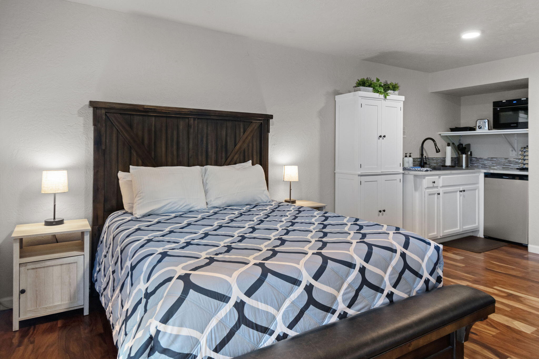17654 Pinnacle Lane, Unit 16 Sunriver, OR 97707 - Photo 13 of 28 a bedroom with a bed and wooden floor