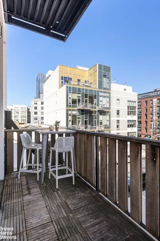 a bedroom with a bed couch and a window