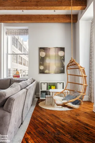 a dining room with furniture and wooden floor
