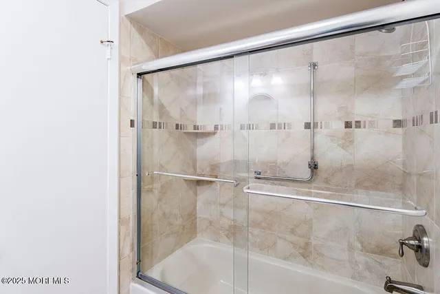 a bathroom with a glass shower door