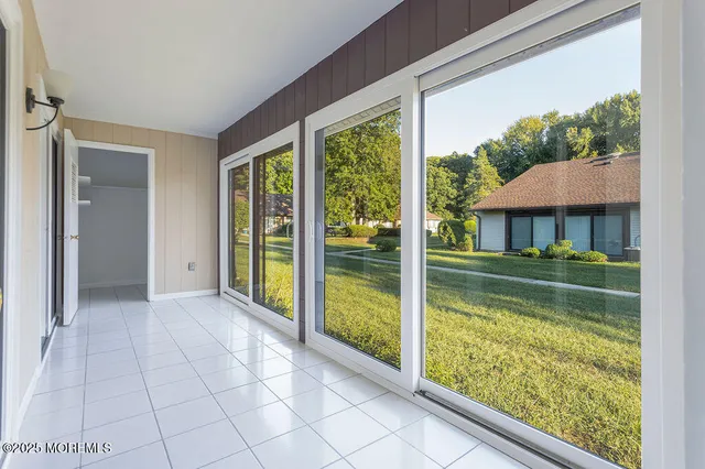 a view of backyard with large trees and a small yard
