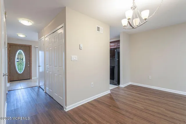 a view of room with window and wooden floor