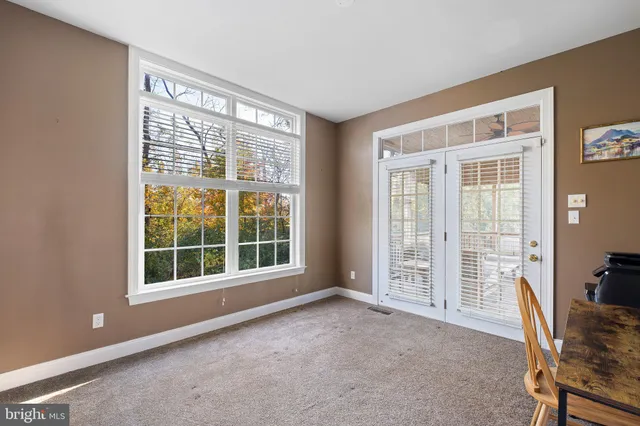 a view of deck with table and chairs under an umbrella