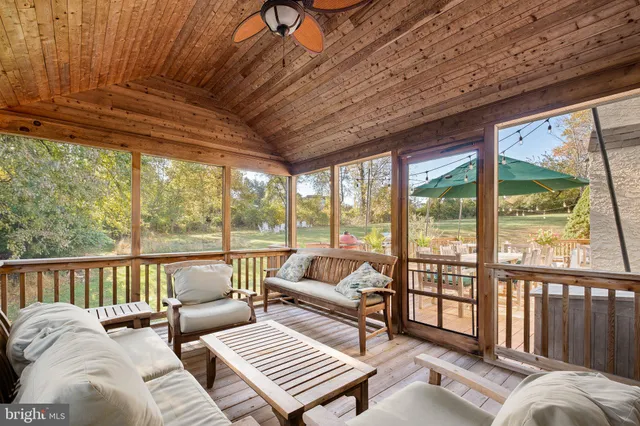 an aerial view of a house with a garden and lake view