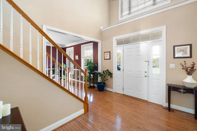 a view of entryway with dining room and wooden floor