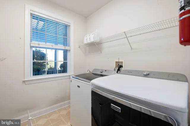 a bathroom with a granite countertop sink a large mirror and a window