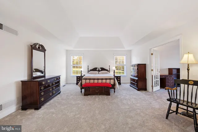 a bedroom with a bed a desk and chair