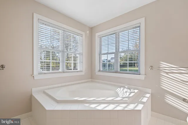 a living room with couch chairs and a large window