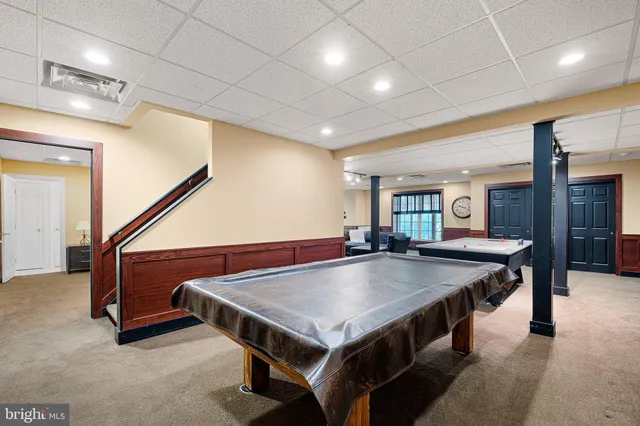 an aerial view of a residential houses with outdoor space and swimming pool