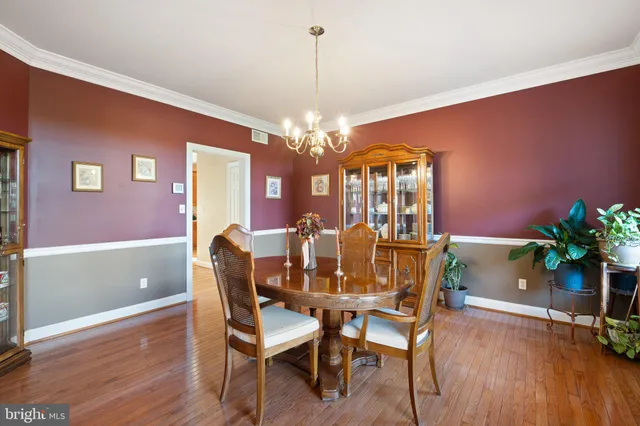 a dining room with furniture and wooden floor