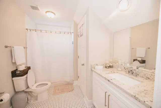 a bathroom with a granite countertop sink a mirror and a