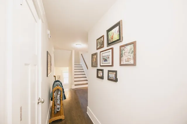 a spacious bathroom with a double vanity sink toilet mirror and shower