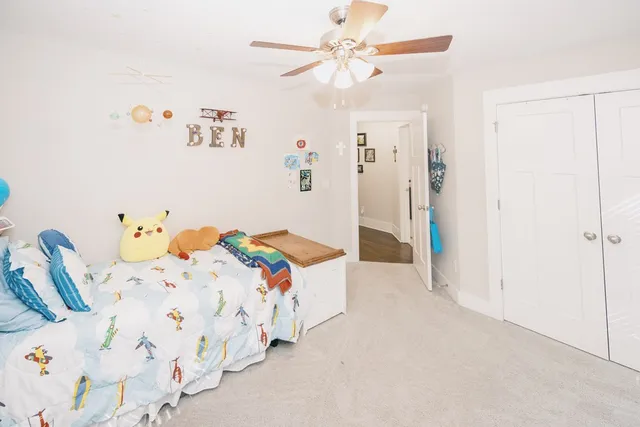 a large bedroom with a bed and a flat screen tv