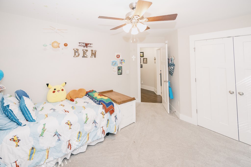 3232 Hillside Way Columbus, GA 31906 - Photo 40 of 61 a bedroom with a bed and a chandelier