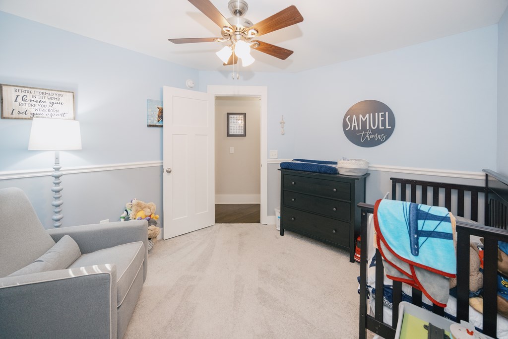 3232 Hillside Way Columbus, GA 31906 - Photo 42 of 61 a bed room with a bed and a chandelier