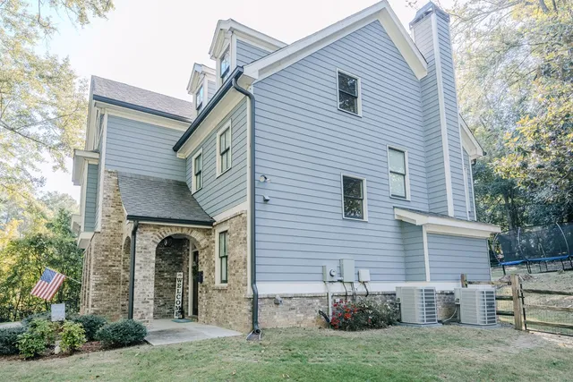 a view of a hallway with wooden floor and furniture