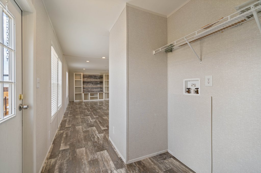 750 Conchas Street Kyle, TX 78640 - Photo 2 of 12 a view of a hallway with wooden floor and staircase