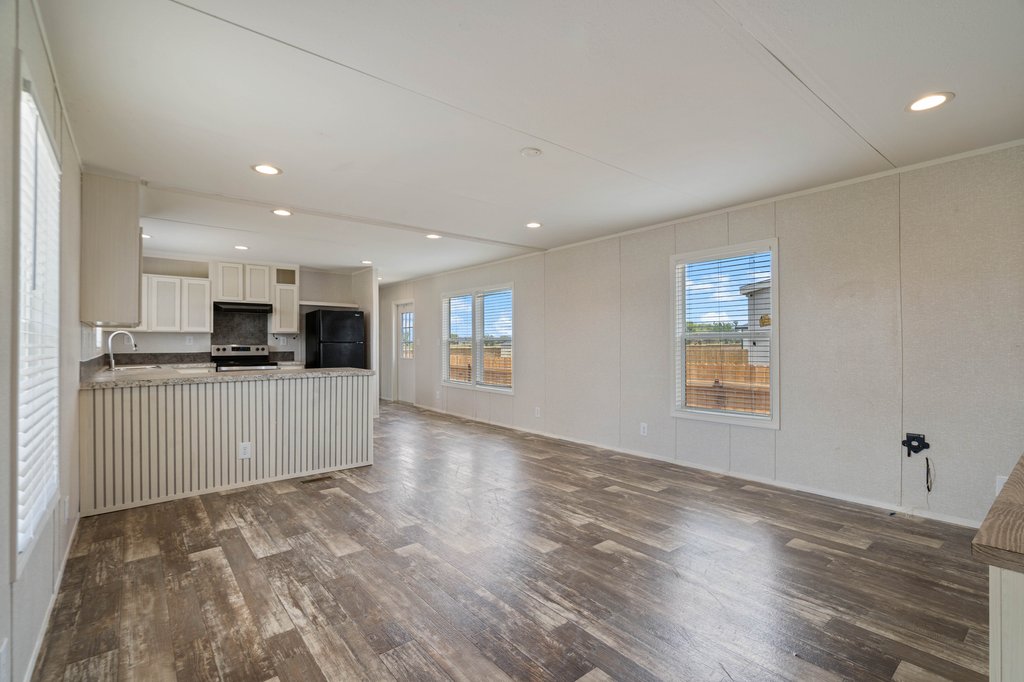 750 Conchas Street Kyle, TX 78640 - Photo 4 of 12 a view of kitchen with kitchen island granite countertop a stove top oven a sink a counter space and cabinets