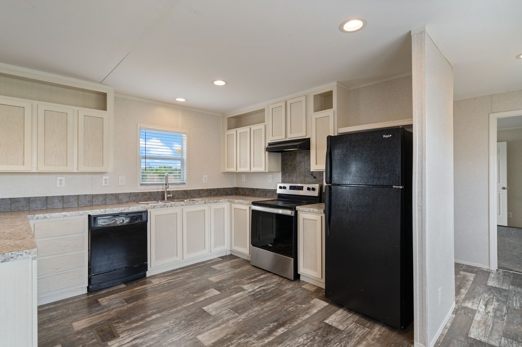 750 Conchas Street Kyle, TX 78640 - Photo 5 of 12 a kitchen with a refrigerator stove and sink