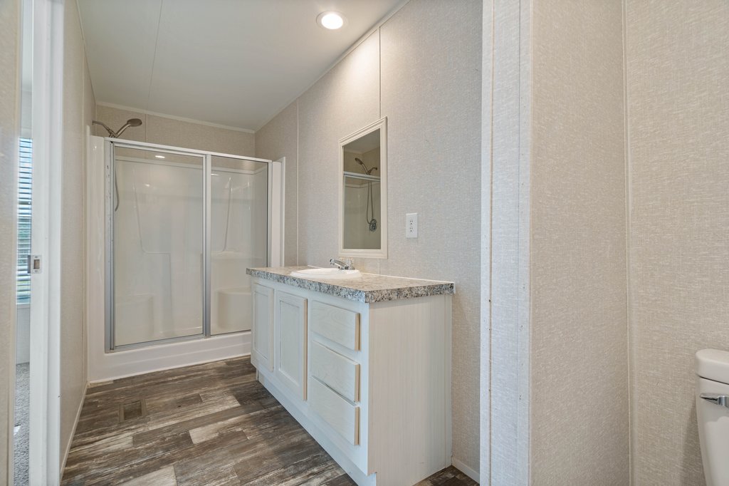 750 Conchas Street Kyle, TX 78640 - Photo 8 of 12 a bathroom with a granite countertop sink and a mirror
