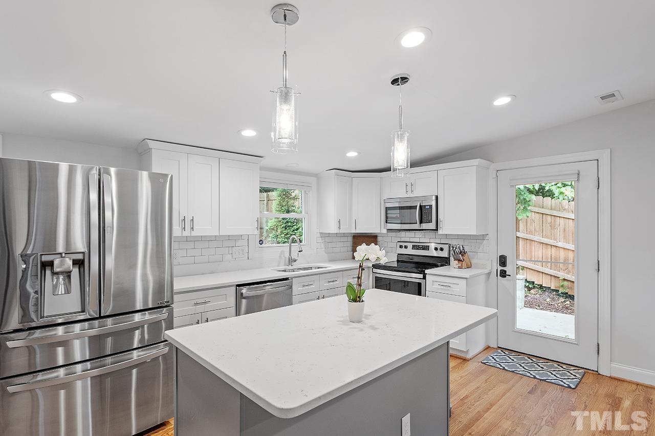 2214 Glascock Street Raleigh, NC 27610 - Photo 14 of 36 a kitchen with a refrigerator a stove a sink and a refrigerator