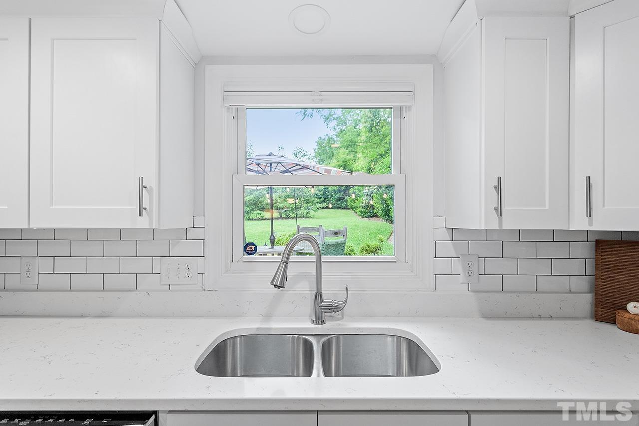 2214 Glascock Street Raleigh, NC 27610 - Photo 16 of 36 a bathroom with a sink a window and tub