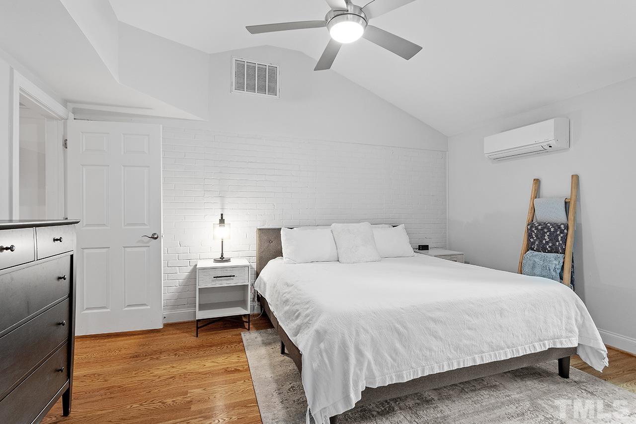 2214 Glascock Street Raleigh, NC 27610 - Photo 18 of 36 a bedroom with a bed and a chandelier