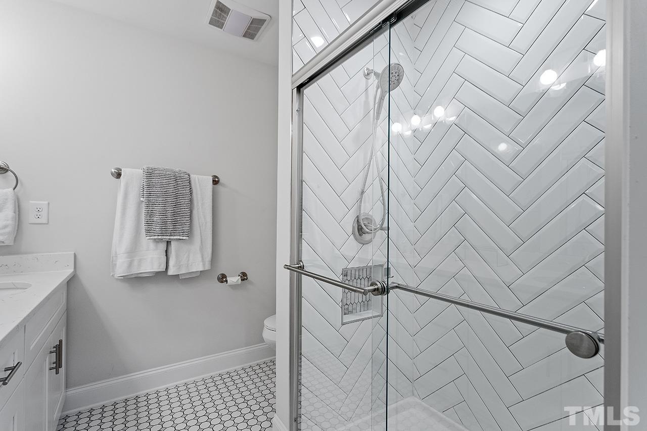 2214 Glascock Street Raleigh, NC 27610 - Photo 21 of 36 a bathroom with a shower and a sink