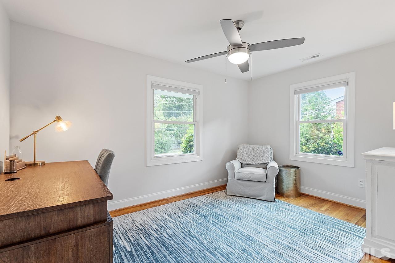 2214 Glascock Street Raleigh, NC 27610 - Photo 24 of 36 a living room with furniture and a wooden floor