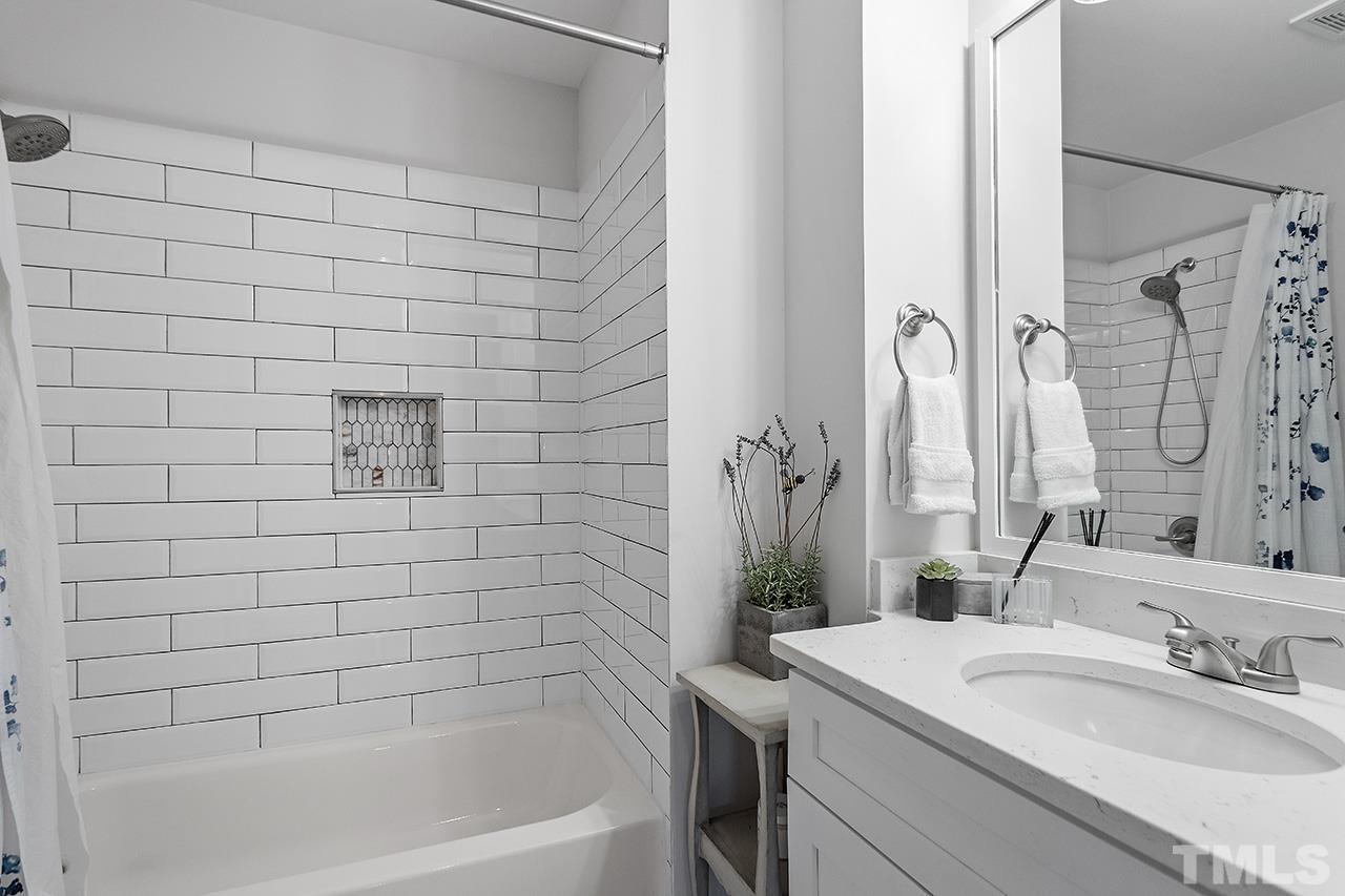 2214 Glascock Street Raleigh, NC 27610 - Photo 28 of 36 a bathroom with a sink and a bathtub