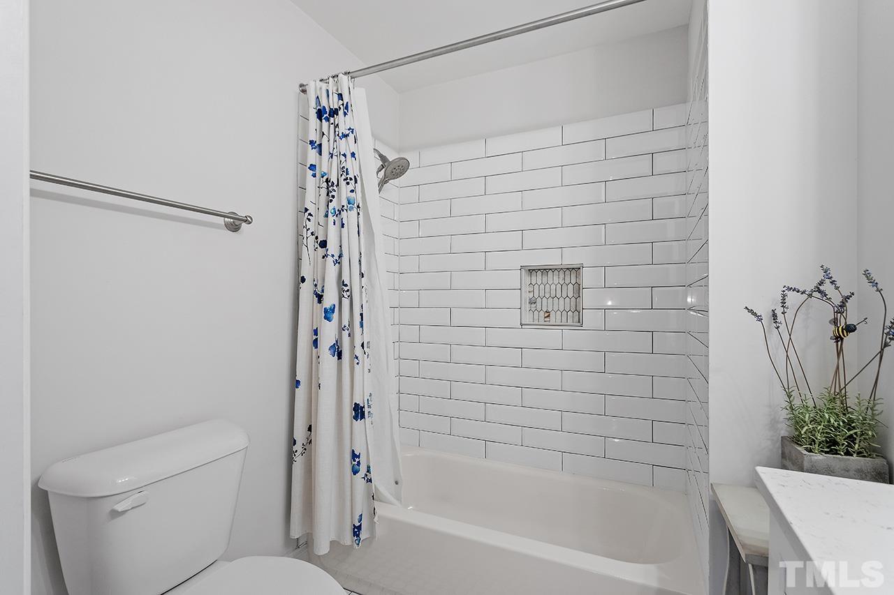 2214 Glascock Street Raleigh, NC 27610 - Photo 29 of 36 a bathroom with a shower and a toilet