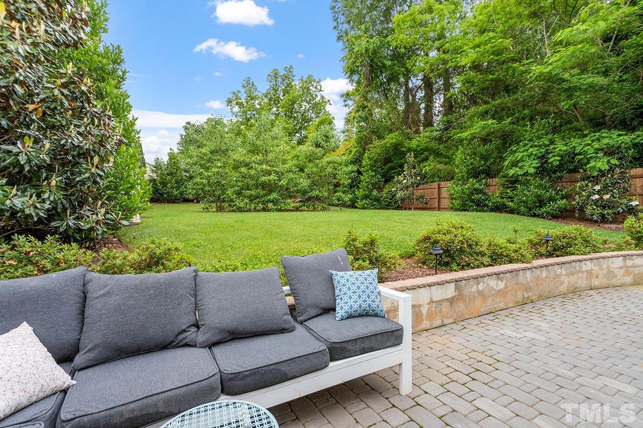 2214 Glascock Street Raleigh, NC 27610 - Photo 32 of 36 a backyard of a house with a garden and outdoor seating