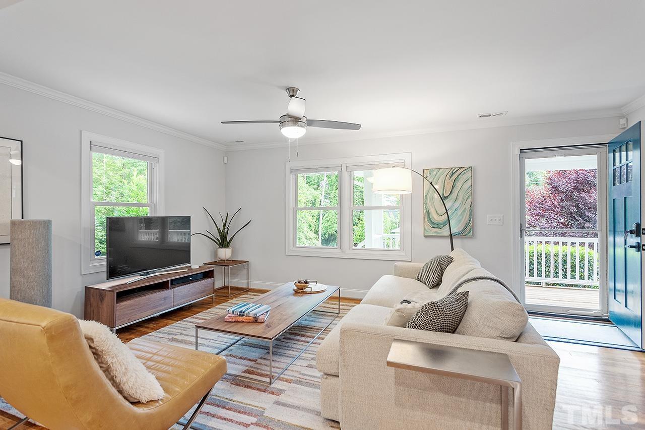2214 Glascock Street Raleigh, NC 27610 - Photo 7 of 36 a living room with furniture a large window and a flat screen tv