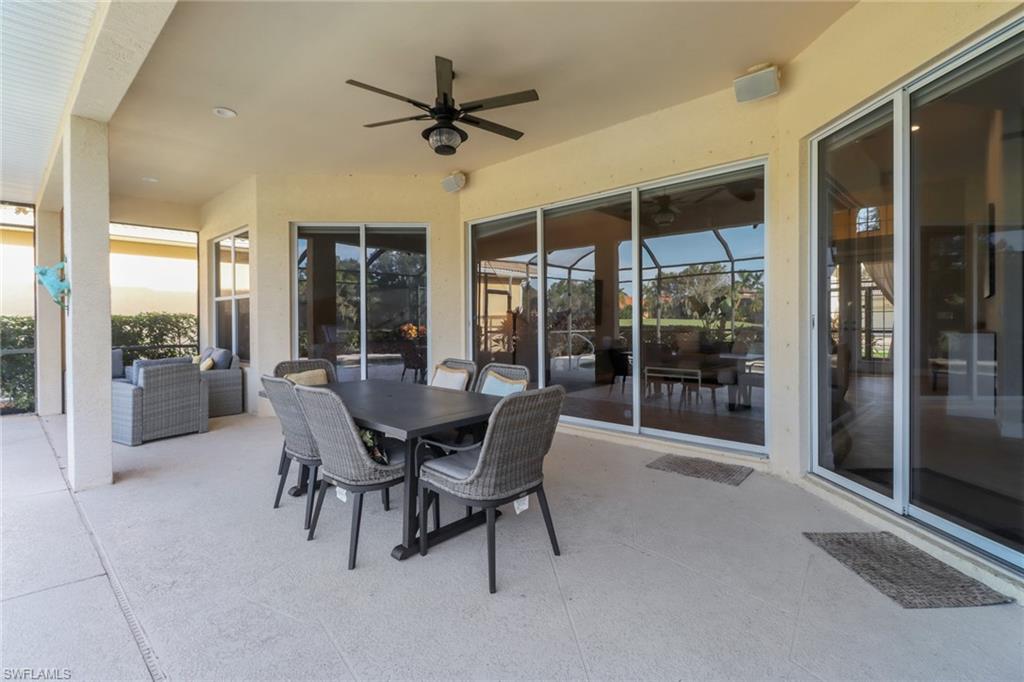 6757 Bent Grass Drive Naples, FL 34113 - Photo 23 of 27 a dining room with furniture and front door
