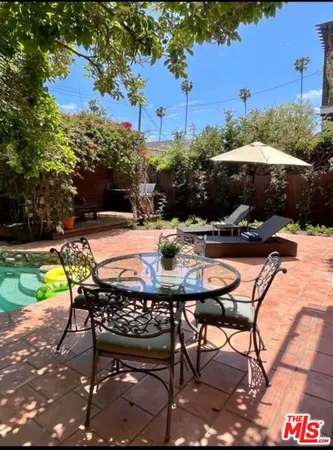 a swimming pool with outdoor seating and yard